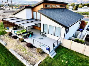 Back of house with a deck with mountain view