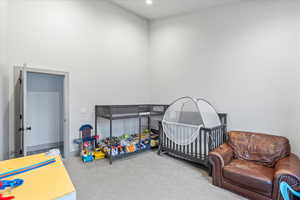 Carpeted bedroom featuring a crib