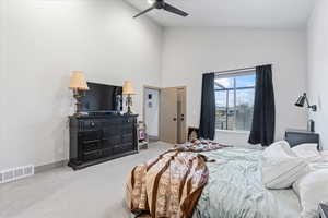 Bedroom featuring carpet floors, high vaulted ceiling, and ceiling fan