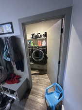 Clothes washing area with wood-type flooring and washer and clothes dryer