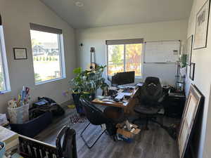 Office area featuring lofted ceiling, wood-type flooring, and plenty of natural light