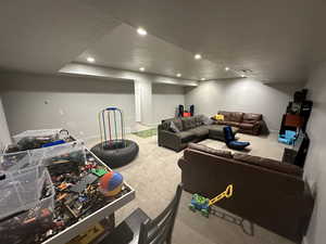 Game room with a textured ceiling and carpet floors