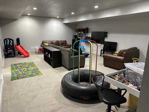 Playroom featuring light carpet and a textured ceiling