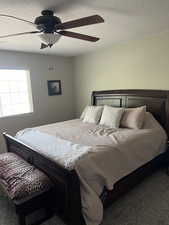 Primary bedroom with ceiling fan and King-sized bed