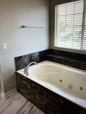 Primary Bathroom with tiled bath