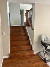 Staircase featuring hard wood flooring