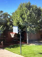 View of sport court featuring a yard