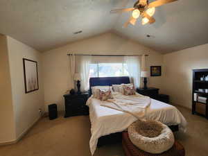 Bedroom featuring light carpet, a textured ceiling, ceiling fan, and lofted ceiling