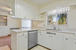 Kitchen featuring kitchen peninsula, dishwasher, cabinets, and sink