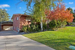 View of side of home and the drive way leading to RV parking and an additional garage/shop.