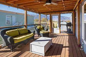 Sunroom featuring a mountain view and ceiling fan