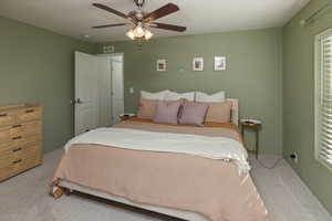 Bedroom with ceiling fan and light colored carpet