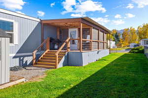 Exterior space featuring a yard and a sunroom