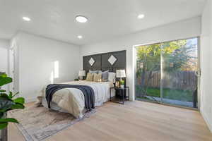 Bedroom with access to exterior backyard and light wood-type flooring