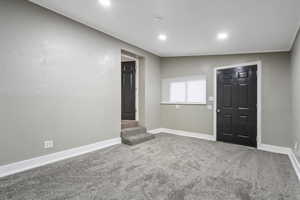 ADU Bedroom with carpet, vaulted ceiling, and crown molding