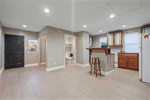 ADU Kitchen featuring white appliances and a breakfast bar area