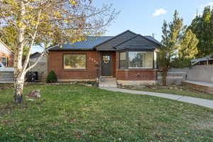 Bungalow-style home featuring a front lawn