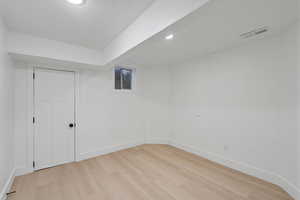 Bedroom  with a textured ceiling and light hardwood / wood-style flooring