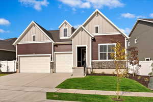 Craftsman-style house with a garage and a front lawn