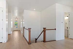 Corridor featuring light wood-type flooring