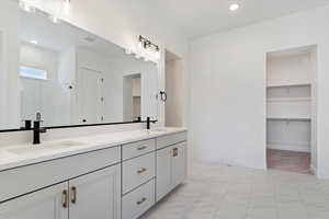 Owners Bathroom featuring vanity and an enclosed shower