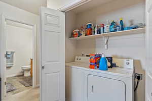 Clothes washing area featuring washing machine and clothes dryer