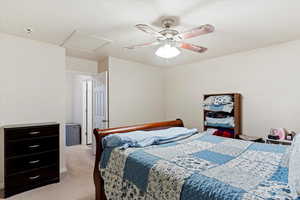 Bedroom with ceiling fan and light carpet