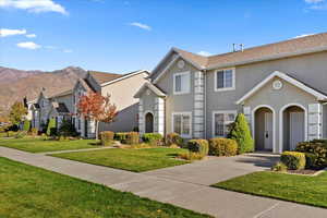 View of front of house featuring a front yard and a mountain view