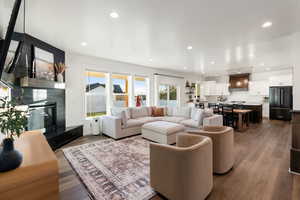 Living room featuring a tiled fireplace and hardwood / wood-style flooring