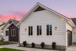 Property exterior at dusk featuring a garage