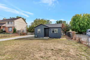 newly painted single level bungalow with a front lawn