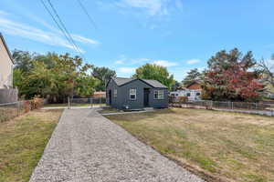 long graveled driveway featuring parking for 4 cars and porch seating area