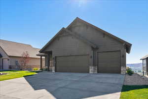 View of front facade featuring a garage and a front lawn