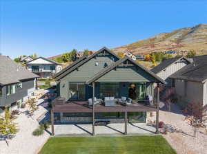 Rear view of house with a mountain view and covered porch