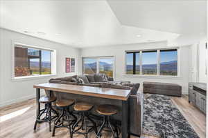 Kitchen featuring a mountain view, light hardwood / wood-style flooring, and a kitchen bar