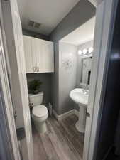 Bathroom with toilet and hardwood / wood-style floors