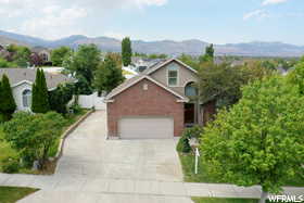 View of front of property with a mountain view and a garage