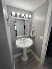 Bathroom featuring sink, hardwood / wood-style floors, and a textured ceiling