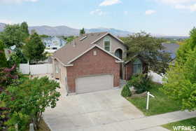 Front of property with a mountain view and a garage