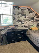 Bedroom with carpet flooring and wallpapered walls