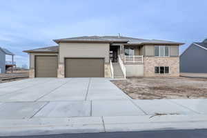 View of front of house with a porch and a garage