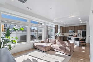 Living room featuring light hardwood / wood-style floors and plenty of natural light