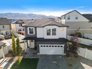 View of front of house with a mountain view and a garage