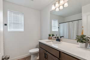 Bathroom with vanity, toilet, and tile patterned flooring