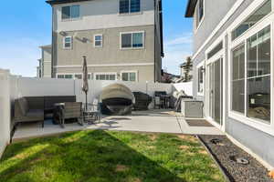 Rear view of house with an outdoor hangout area, a patio area, and a lawn