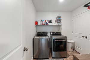 Laundry room featuring independent washer and dryer