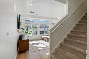 Stairs featuring wood-type flooring