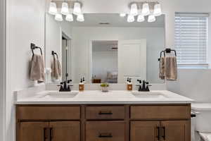 Bathroom featuring vanity and toilet