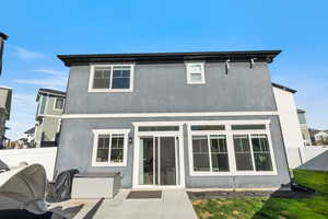 Rear view of house featuring a patio