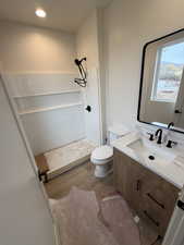 Bathroom with vanity, hardwood / wood-style floors, toilet, and walk in shower